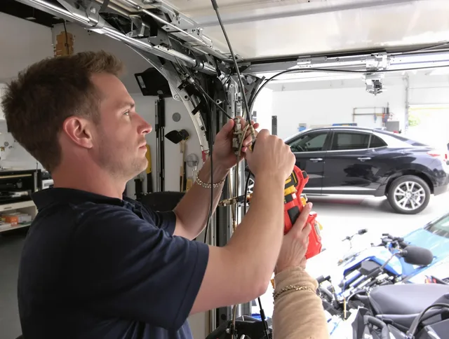 New Franklin Garage Door Repair safety certified technician performing cable replacement in New Franklin